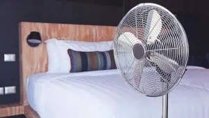 bed with standing fan summer sleep tips