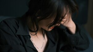 Person holding their head in pain, illustrating the frustration of chronic pain flares